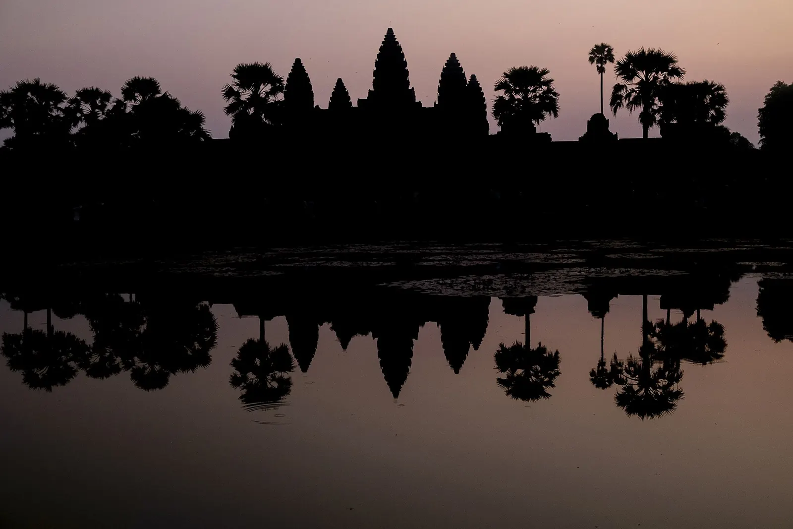 Angkor Wat reflected in its pool at sunrise